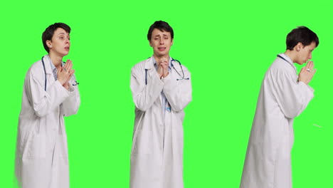 Hopeful-physician-holding-hands-in-a-prayer-sign-against-greenscreen